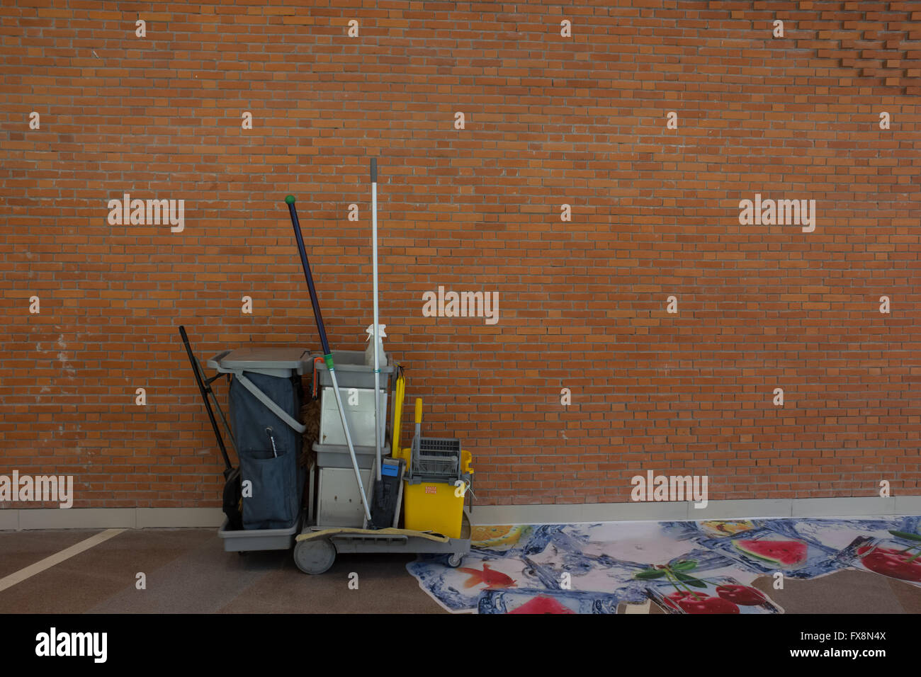 Carrello di pulizia marrone e un muro di mattoni sfondo astratto Foto Stock