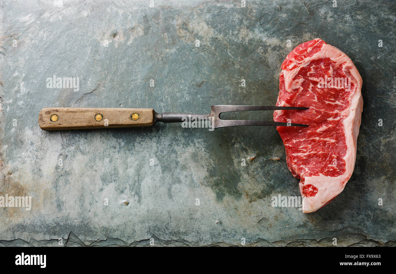 Materie carni fresche bistecca di controfiletto e forcella di carne su pietra grigia sullo sfondo di ardesia Foto Stock