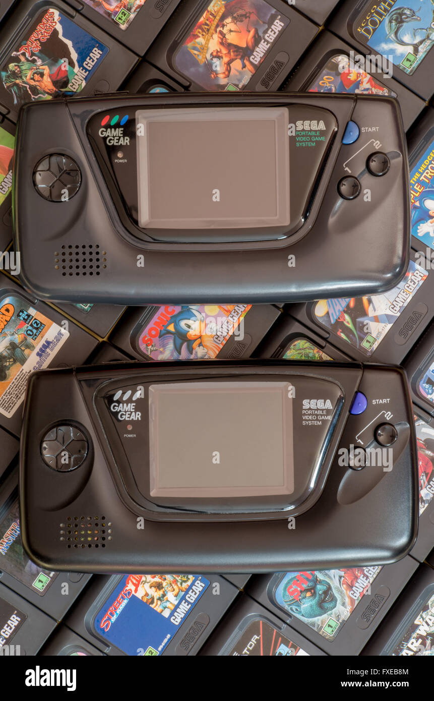 Due Sega Game Gear video gioco di unità - l'originale 1990 release e la Majesco versione da 2001 - su un letto di cartucce. Foto Stock