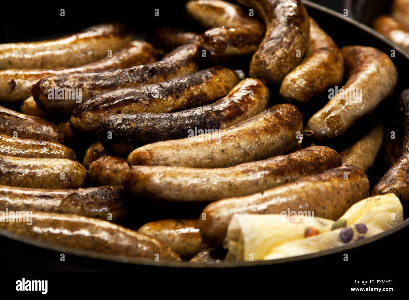 Mercatino di Natale di Lincoln, Lincolnshire, Inghilterra, salsiccia frittura ad un stand in fiera. Foto Stock