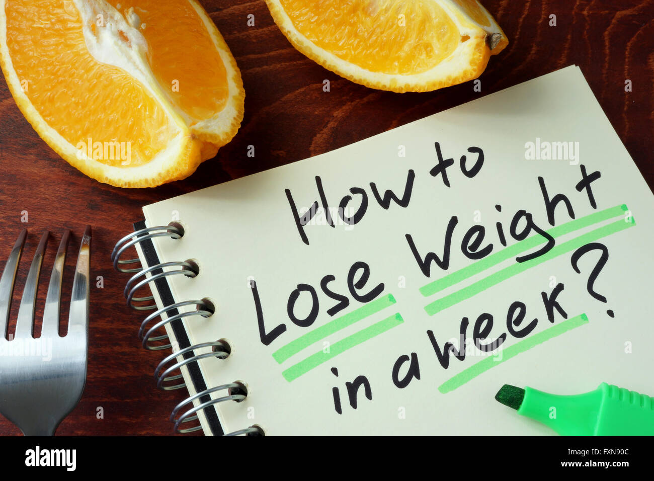 Blocco note con il segno come perdere peso in una settimana. Foto Stock