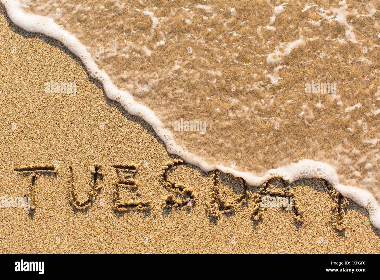 Martedì - tratto della mano sulla spiaggia di sabbia, morbide onde da surf. Foto Stock