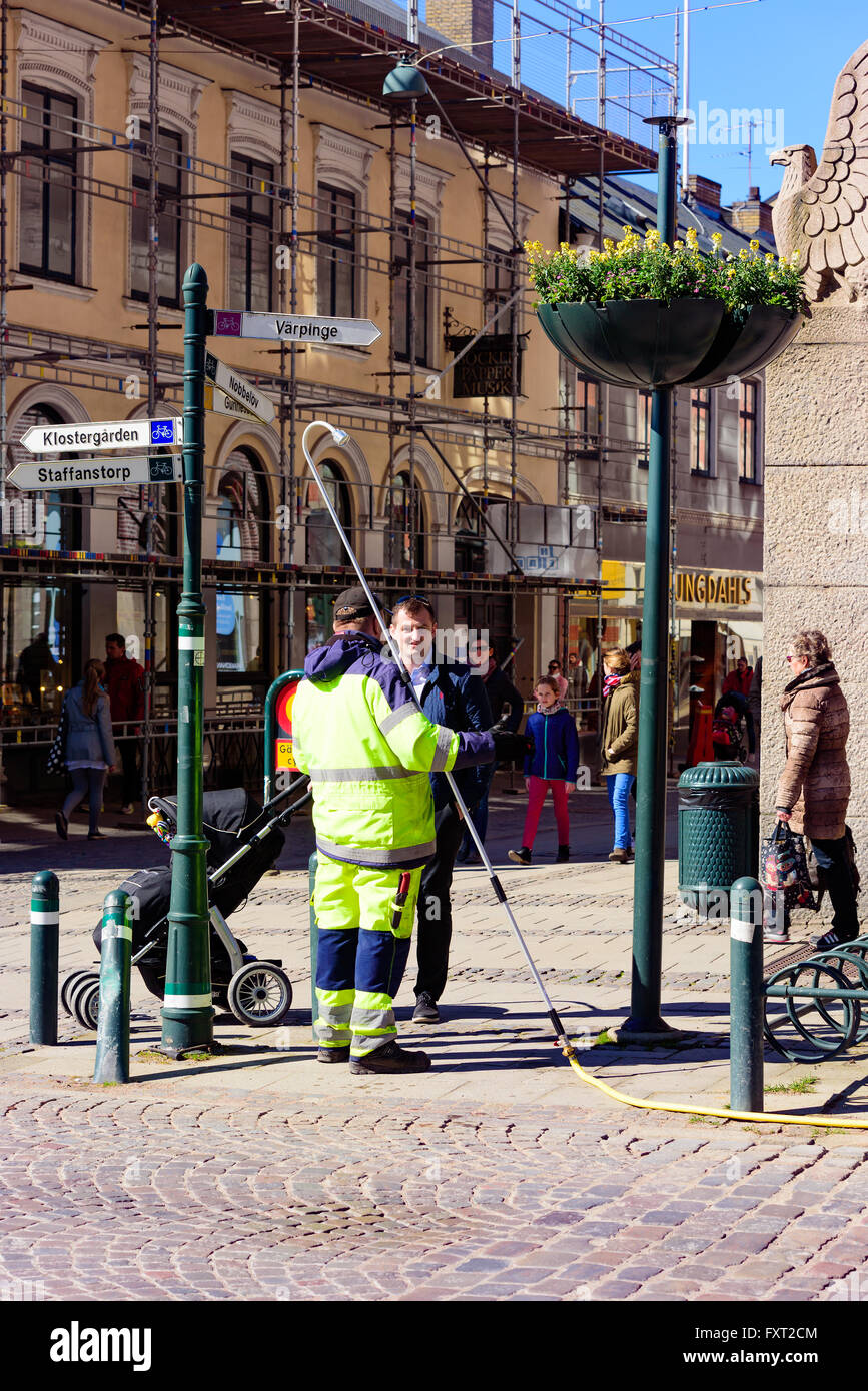 Lund, Svezia - 11 Aprile 2016: La vita quotidiana della città. Un uomo con un passeggino ha iniziato a parlare con un lavoratore tenendo un lungo w Foto Stock