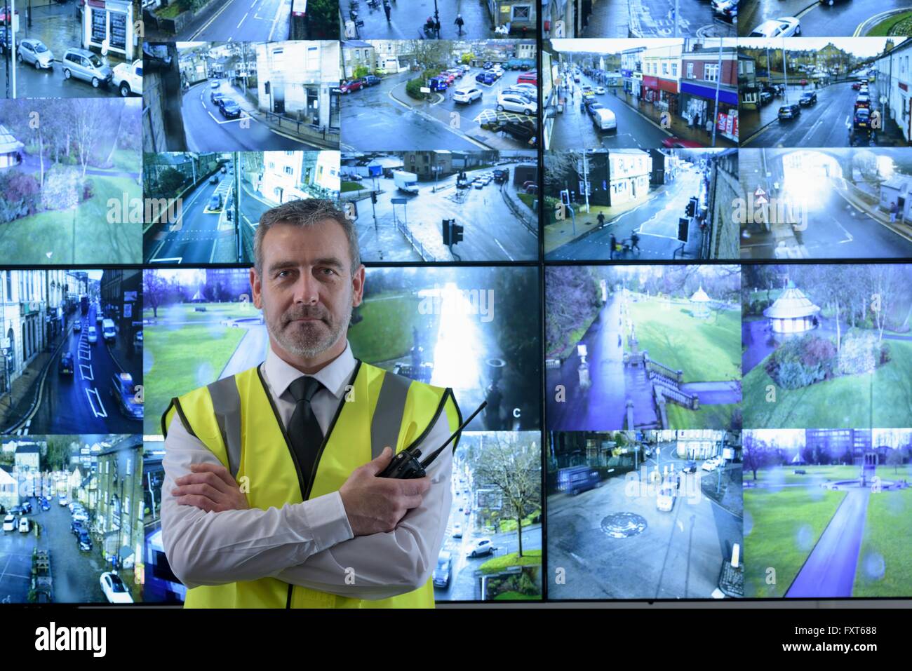 Ritratto di guardia di sicurezza di fronte in video a parete nella sala di controllo per la sicurezza Foto Stock