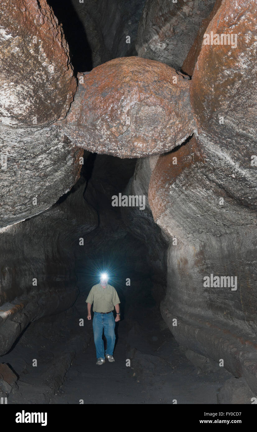 Ape Cave, tubo di lava, Mt. Sant Helens monumento nazionale, Escursionista sotto 'La polpetta' e un pezzo di basalto presentata nella grotta del tetto Foto Stock