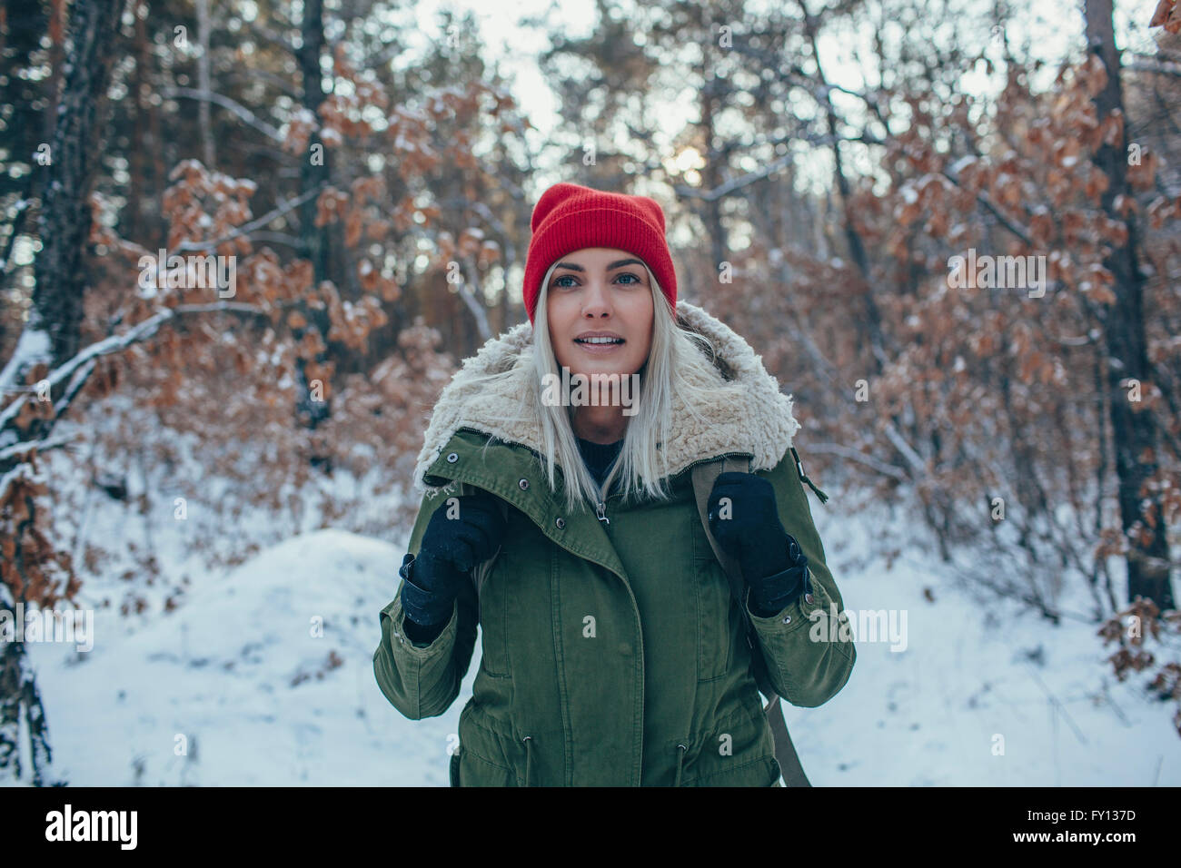 Giovane donna indossa knit hat e giacca mentre guarda lontano Foto Stock