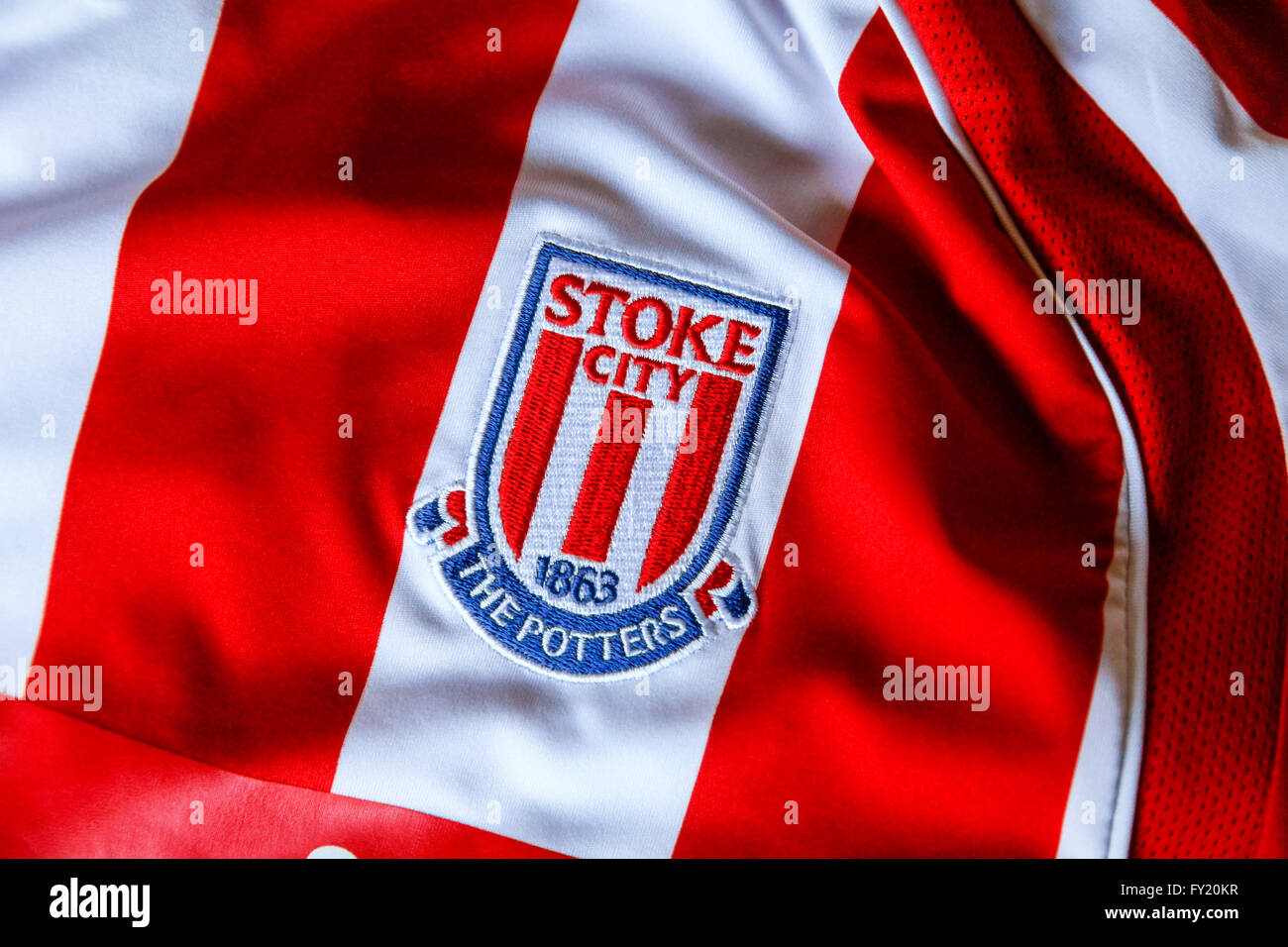 Un distintivo su una rossa e bianca a strisce football shirt di Stoke City Football Club precedentemente della Premier League inglese (EPL) ma ora in campionato Foto Stock