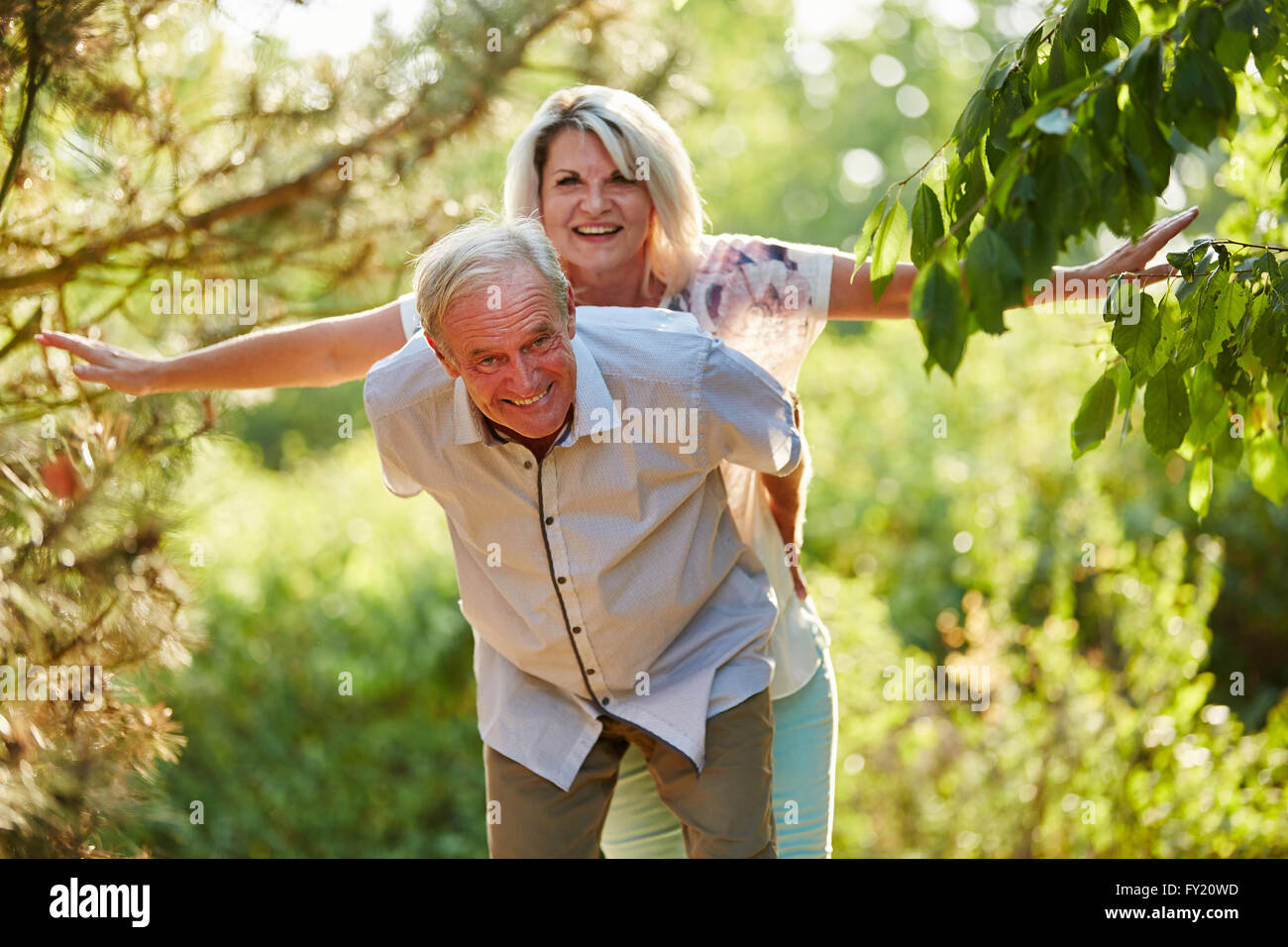 Coppia senior facendo piggyback divertendosi Foto Stock