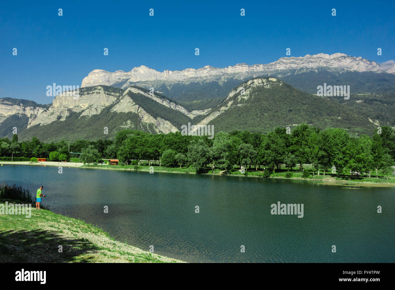 La Francia, La Terrasse, Carouge Lago. Pescatore è la pesca sul lago con vista sulla montagna Foto Stock