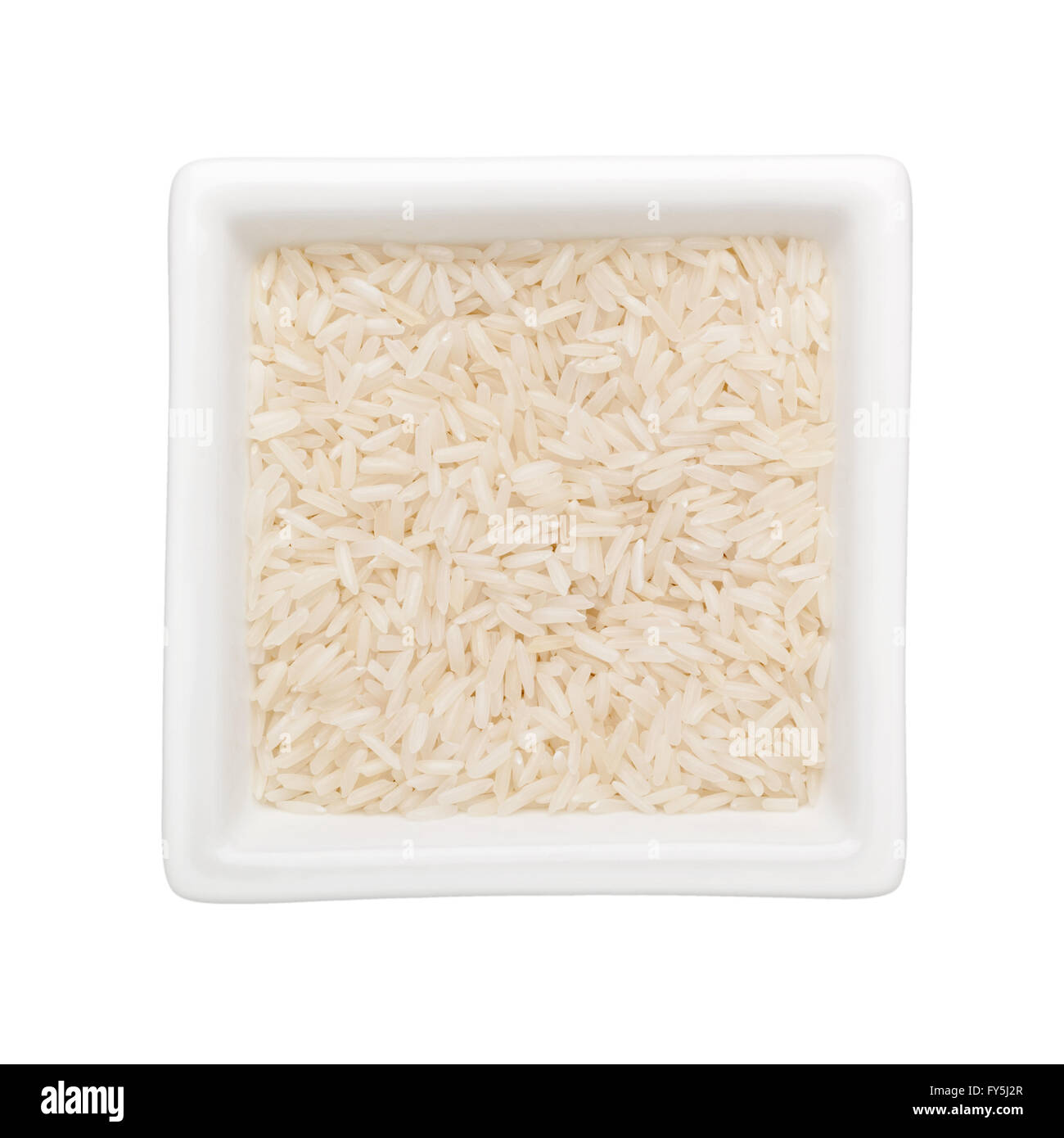 Riso a grani lunghi in un recipiente quadrato isolato su sfondo bianco Foto Stock
