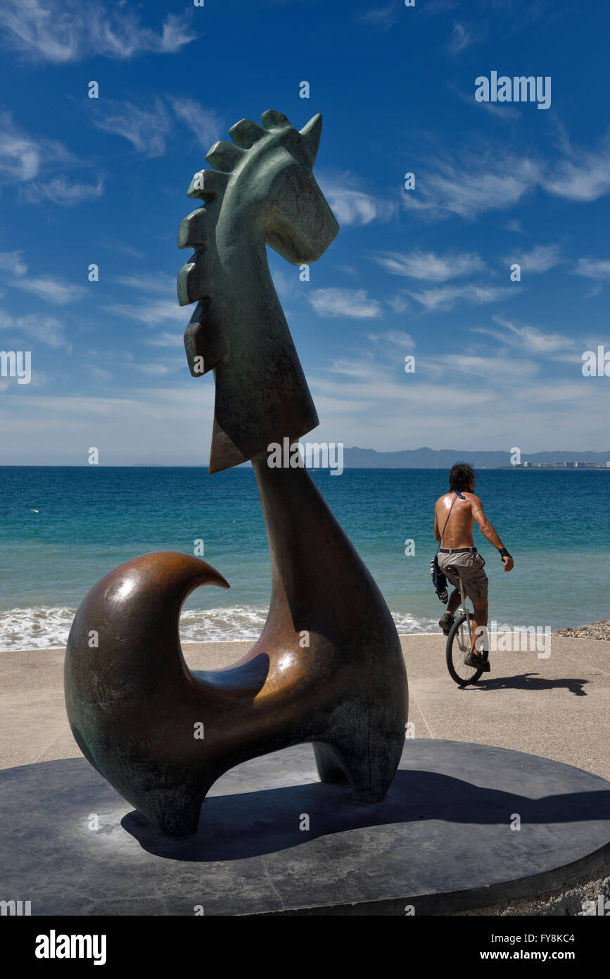 Un unicyclist sul Malecon con la fortuna unicorn scultura Puerto Vallarta Foto Stock