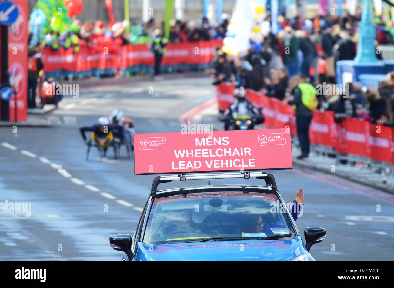 Maratona di Londra 2016. Gli uomini del leader di sedie a rotelle e condurre il veicolo Foto Stock