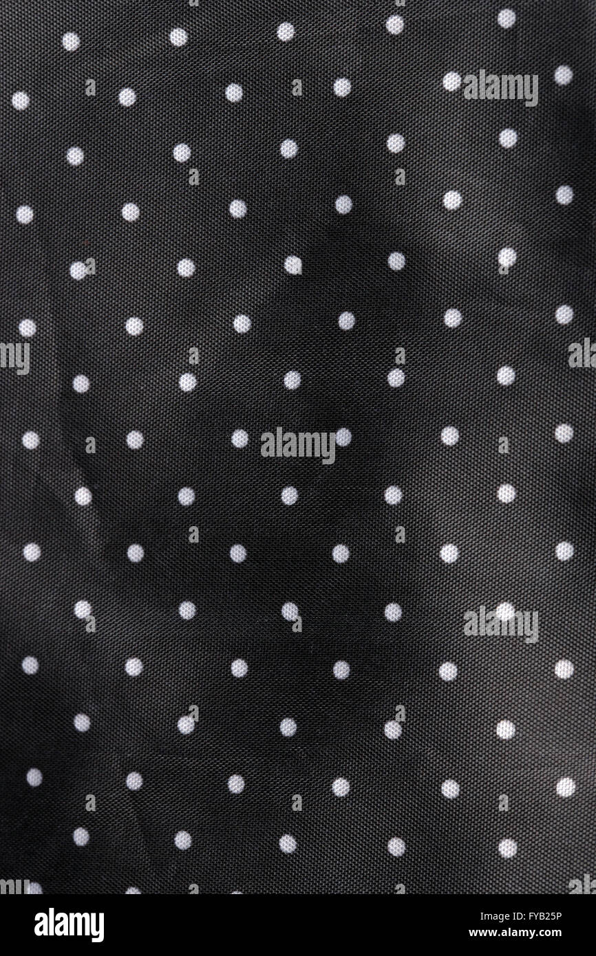 Tessuto nero lo sfondo con puntini bianchi Foto Stock
