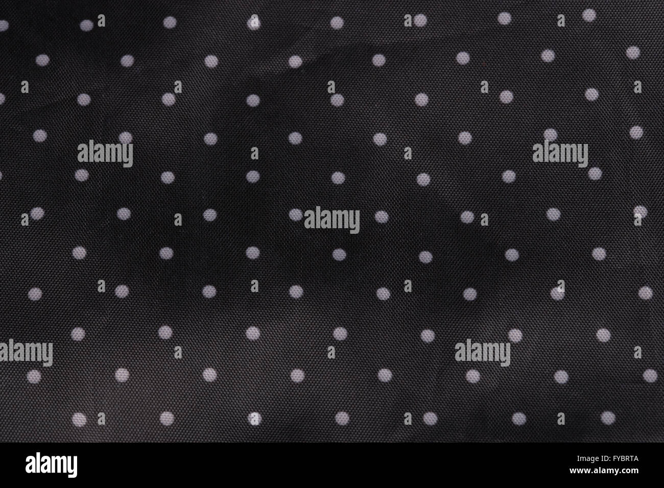 Tessuto nero lo sfondo con puntini bianchi Foto Stock