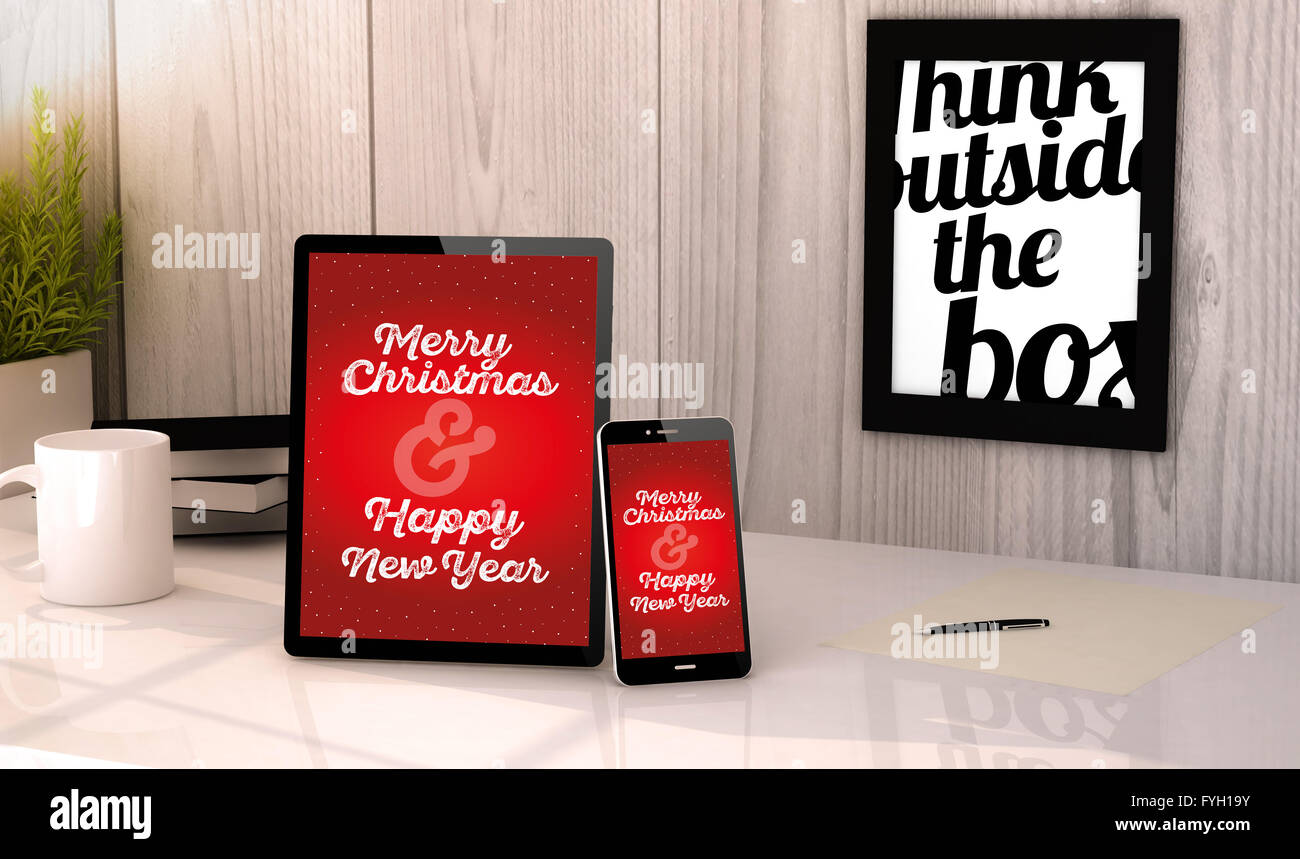 Generata digitale compressa e telefono sul desktop di un luogo di lavoro con il messaggio di saluto di Natale sullo schermo. Tutti i grafici sono fatti. Foto Stock