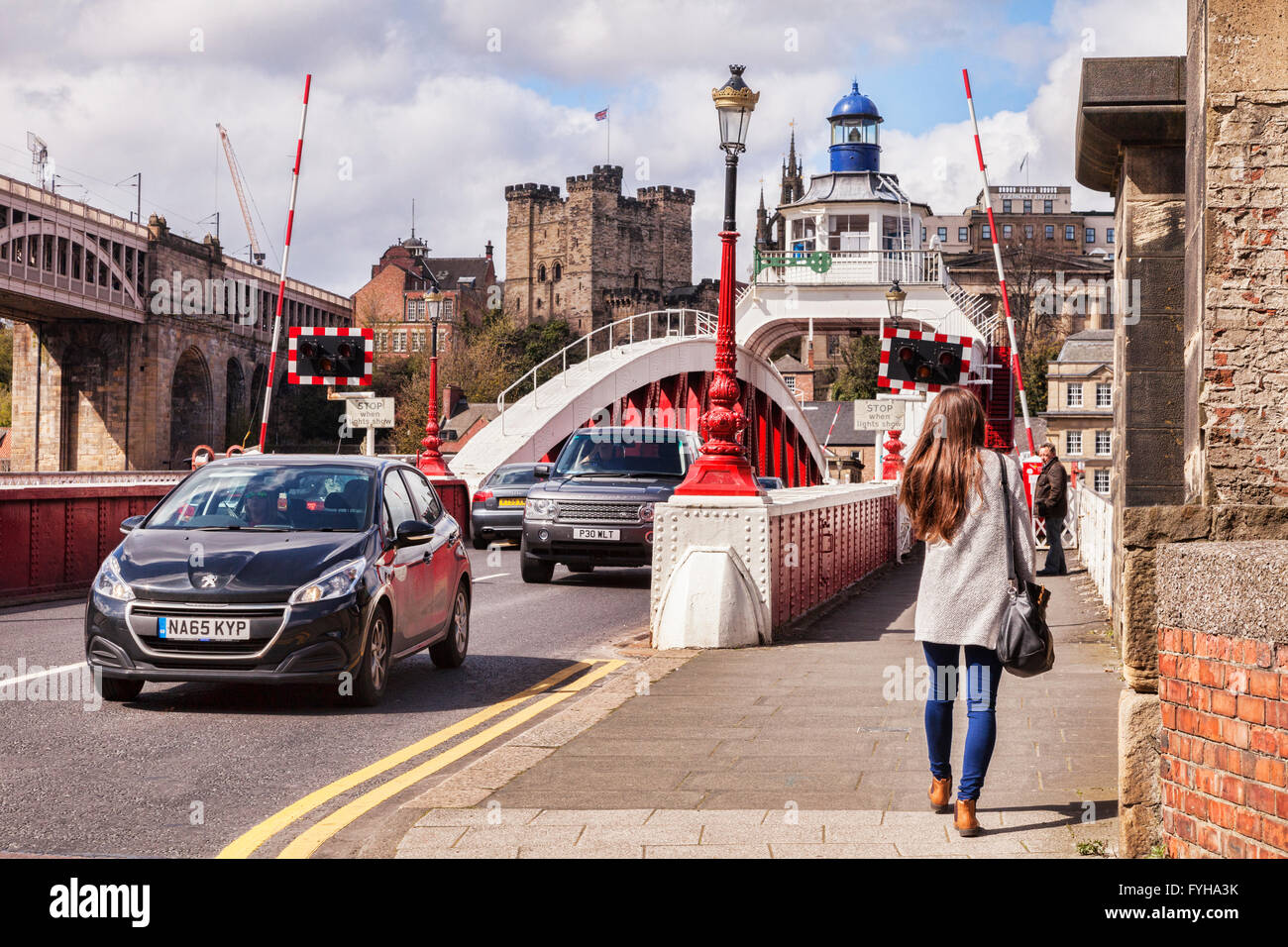 Giovane donna attraversando a piedi il Ponte Girevole, Newcastle-upon-Tyne, Tyne and Wear, Inghilterra, Regno Unito. Il viadotto ferroviario, noto come Foto Stock