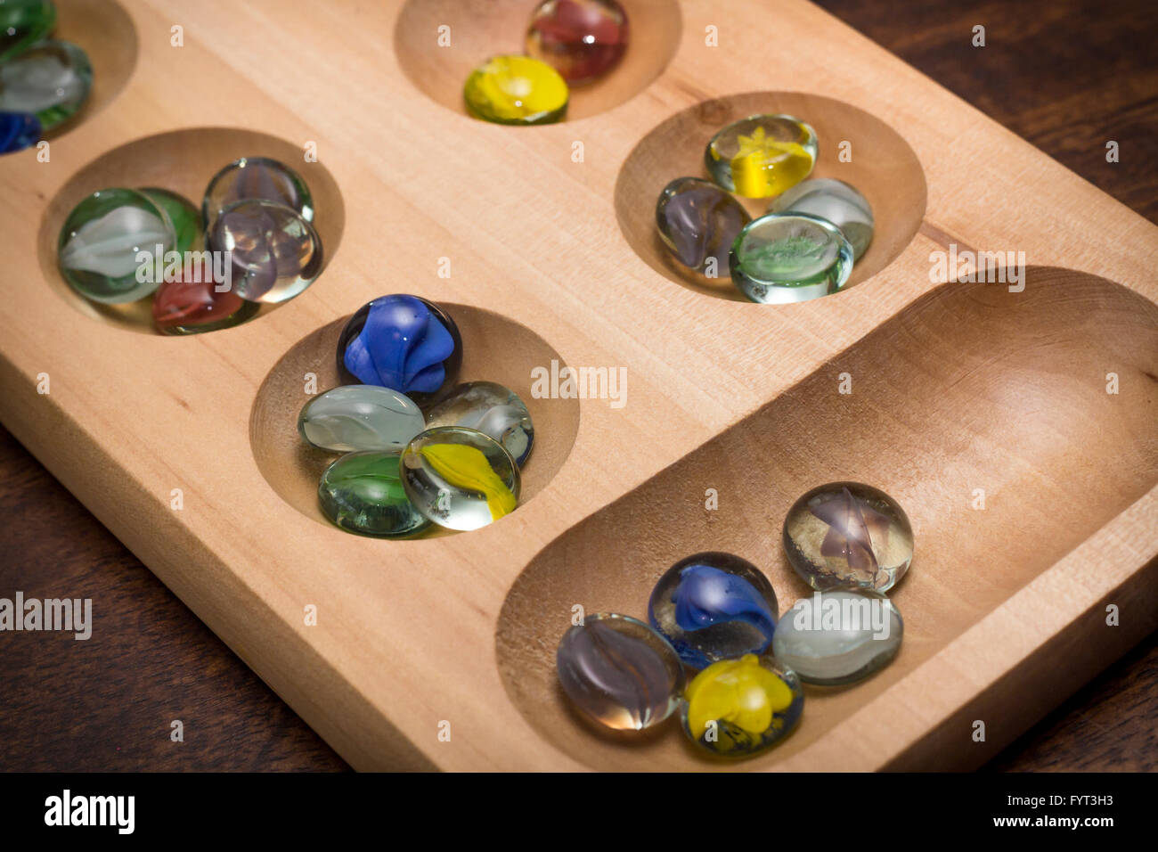 Mancala tradizionale tavolo con pezzi di vetro sul tavolo di legno Foto Stock