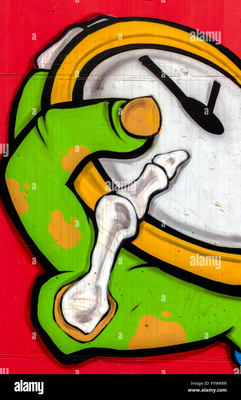 I graffiti sulla parete raffigurante una mano di zombie con un orologio Foto Stock