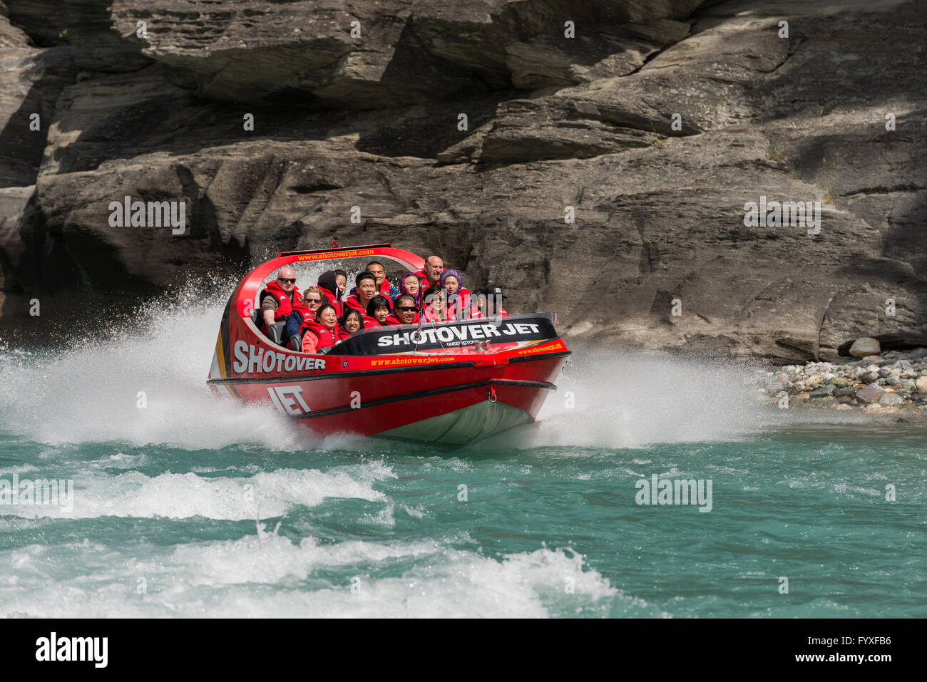 Gruppo di turisti il jet boating sul fiume Shotover a Arthurs Point, Queenstown, Otago,'Isola Sud della Nuova Zelanda. Foto Stock