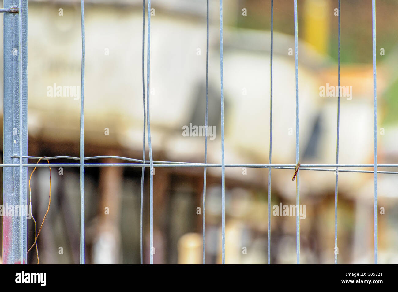 Guardando attraverso le maglie di una recinzione di costruzione Foto Stock