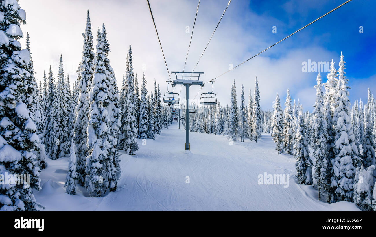 Seggiovia tra coperta di neve alberi in alta alpine presso il famoso villaggio di sci dei picchi di Sun in British Columbia in Canada Occidentale Foto Stock