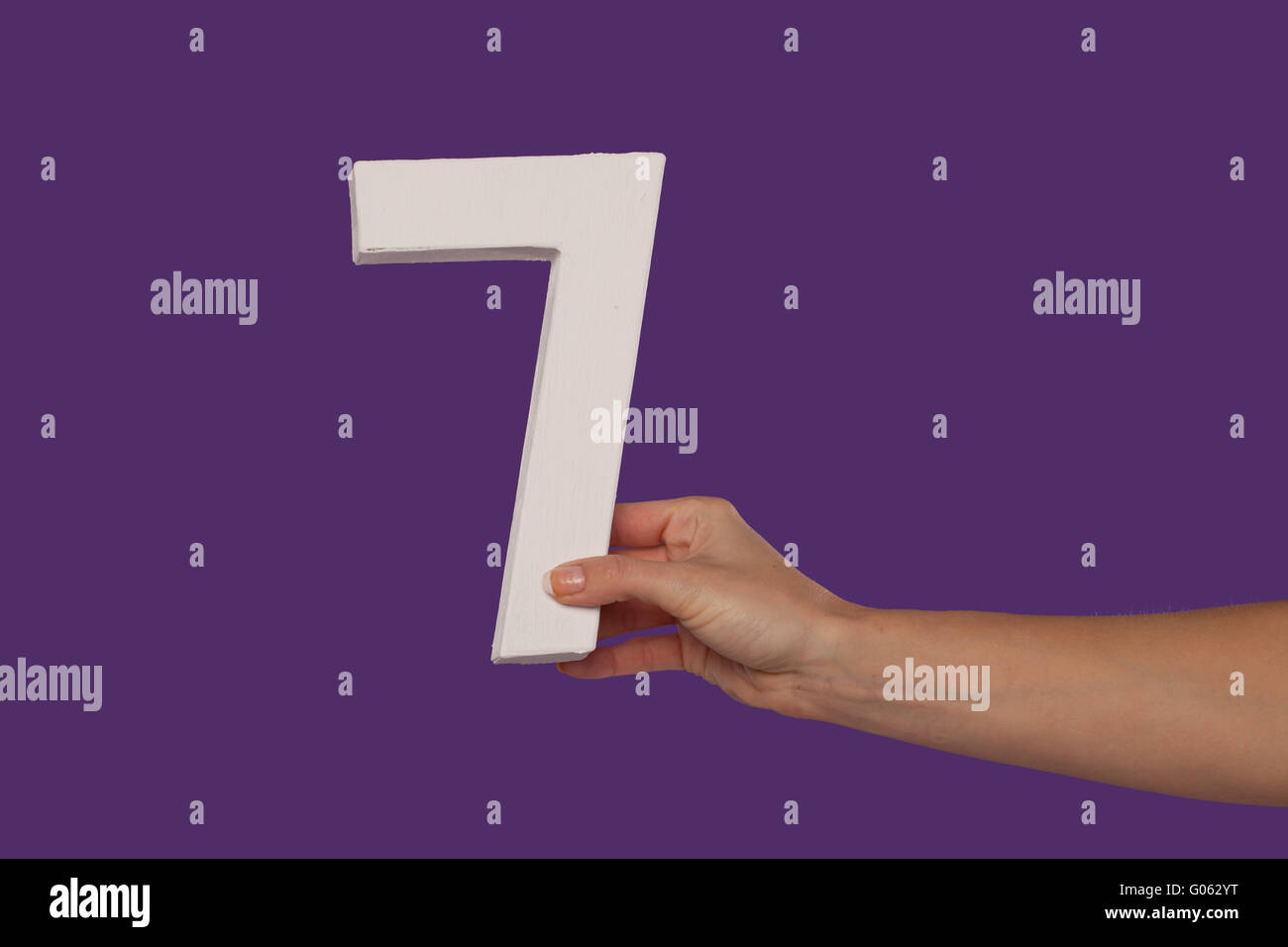 Femmina tenuta a mano fino al numero 7 da destra Foto Stock