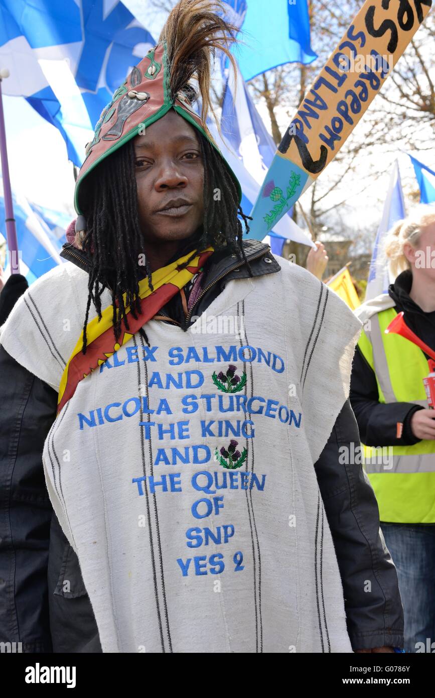 Glasgow, Scozia. Il 30 marzo, 2016. Un uomo dreadlocked indossando un poncho con le parole "Alex Salmond e Nicola lo storione il Re e la regina di SNP sì " a marzo per l'indipendenza attraverso il centro della città di Glasgow. Foto Stock