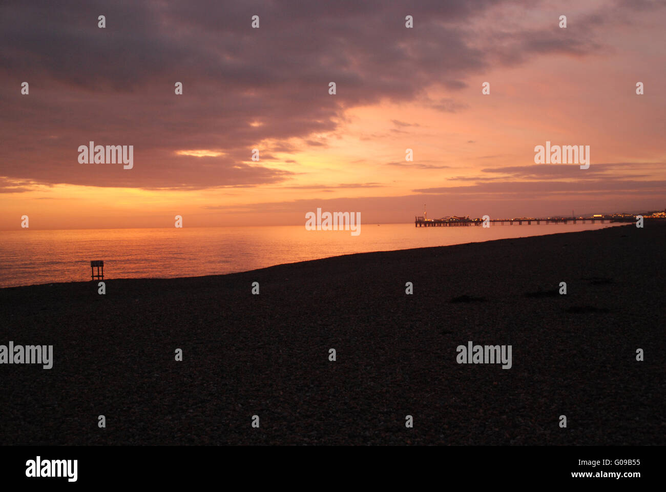 Tramonto sulla spiaggia di Brighton Brighton Pier a distanza Foto Stock