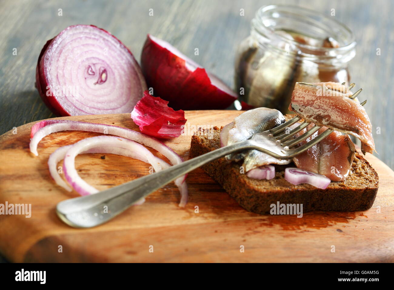 Forcella con acciughe, pane di segale e cipolla rossa. Foto Stock