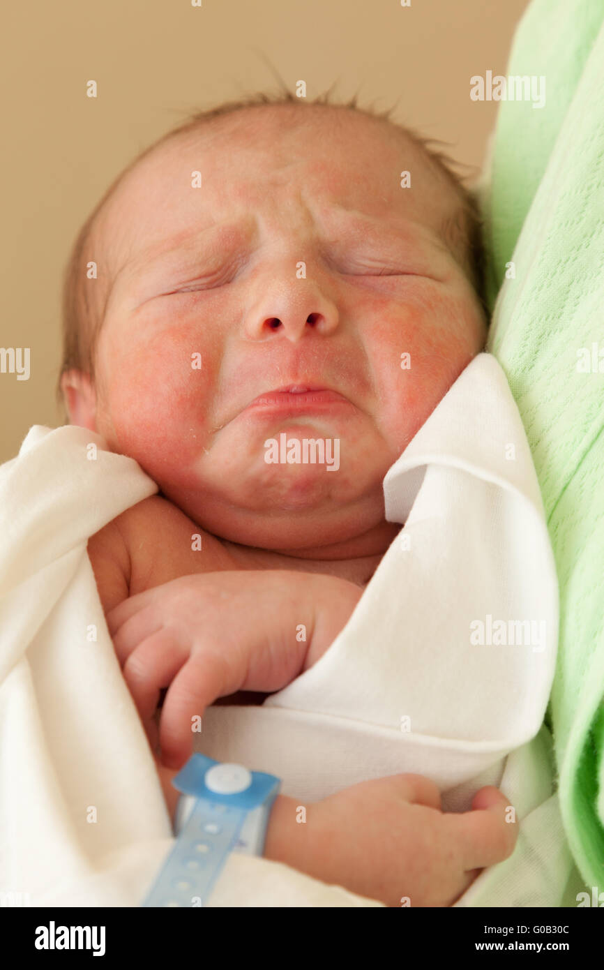 Carino sleeping neonato bambino sulla madre le mani Foto Stock