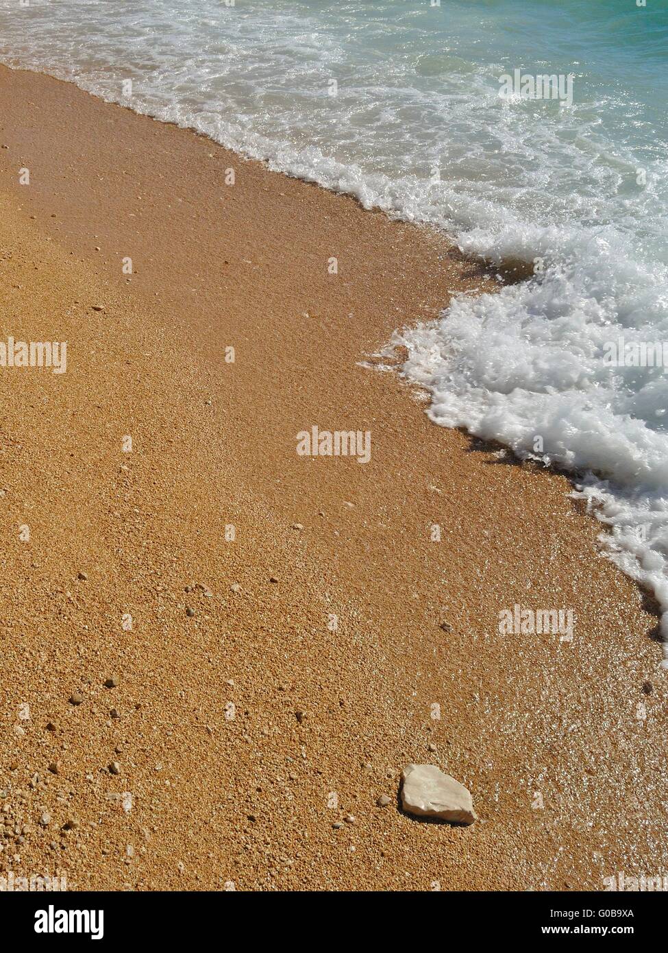 Onde sulla bella spiaggia di sabbia e roccia in podgora, Croazia Foto Stock