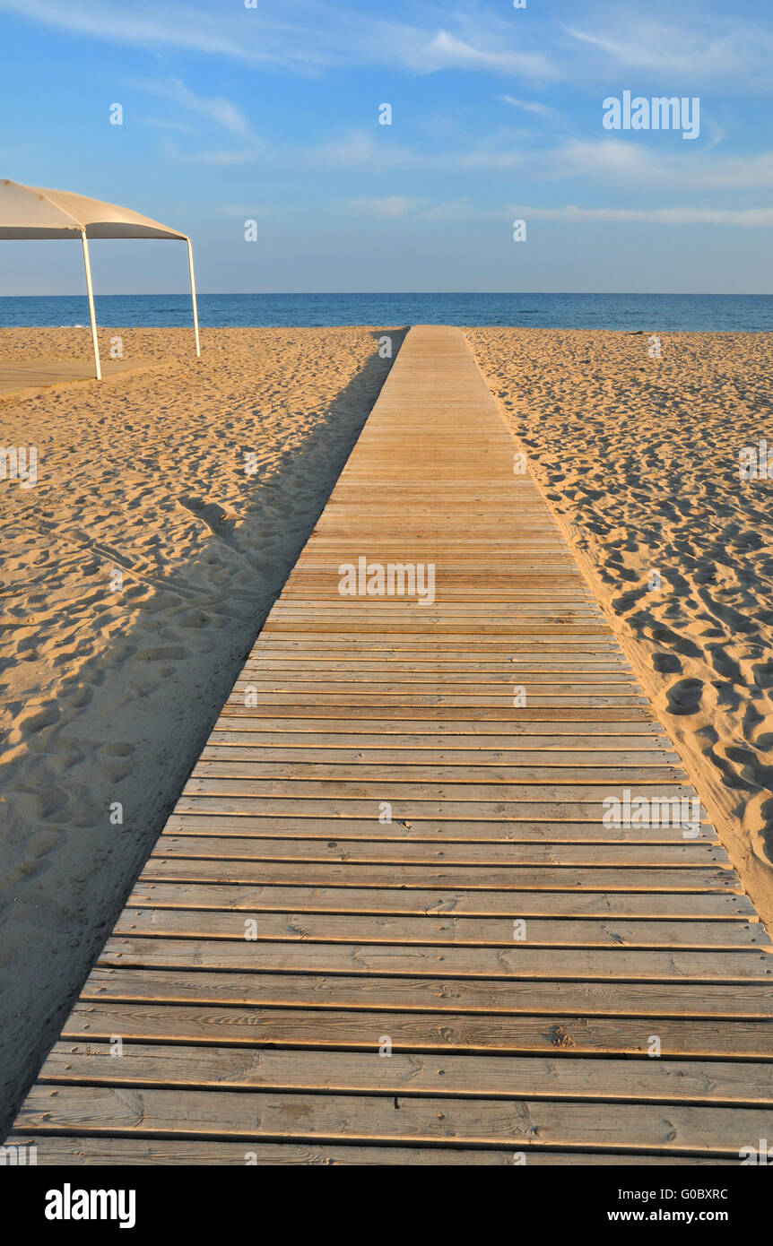 Rettilineo percorso di legno sul vuoto spiaggia di sera in Spagna Foto Stock