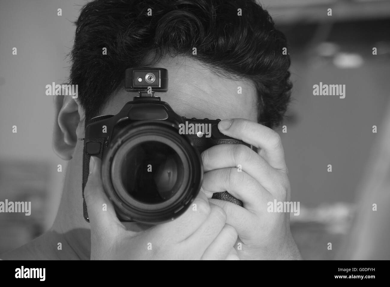 Fotografo di prendere foto con la sua macchina fotografica in bianco e nero monocromatico Foto Stock