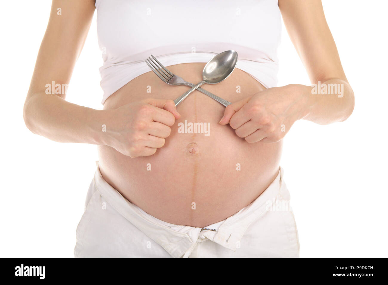 Gli stomaci di donne in gravidanza con un cucchiaio e forchetta Foto Stock