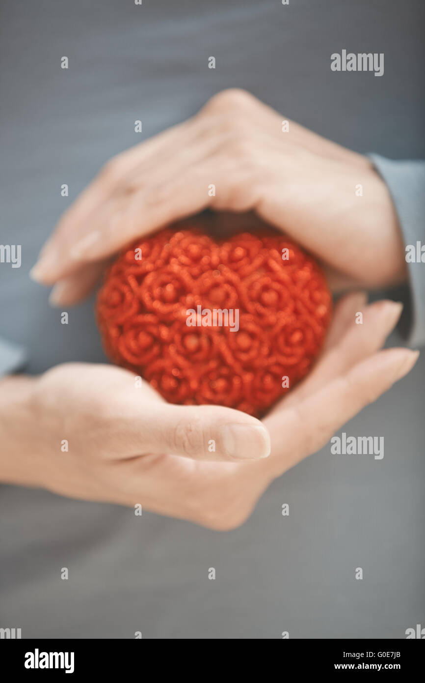 Cuore in mani Foto Stock