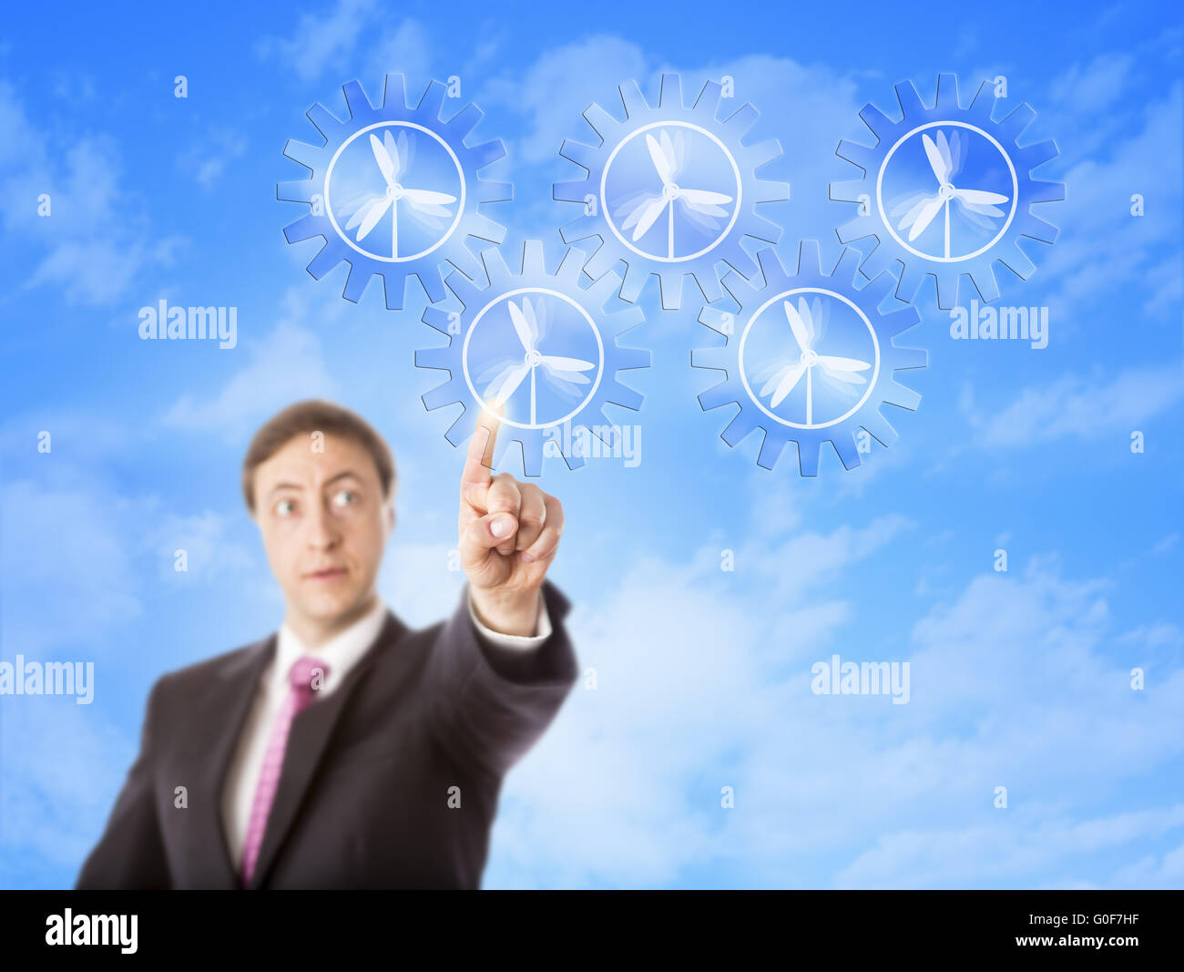 Imprenditore guardando il potere di vento treno ingranaggi Foto Stock