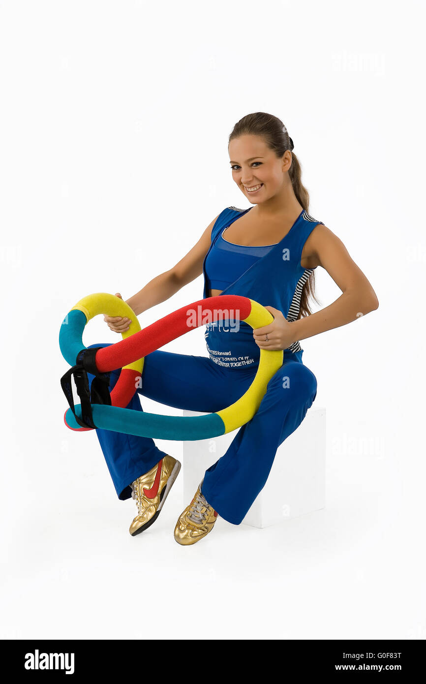 Giovane donna e dispositivo di formazione Foto Stock