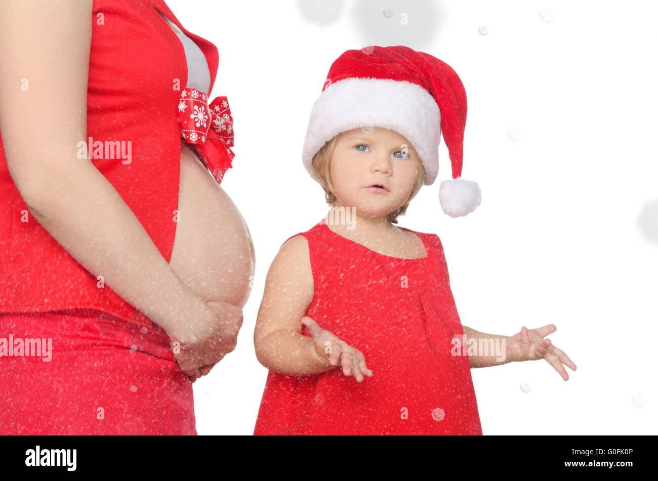 Sorpreso il bambino e la donna incinta a Natale, i fiocchi di neve Foto Stock