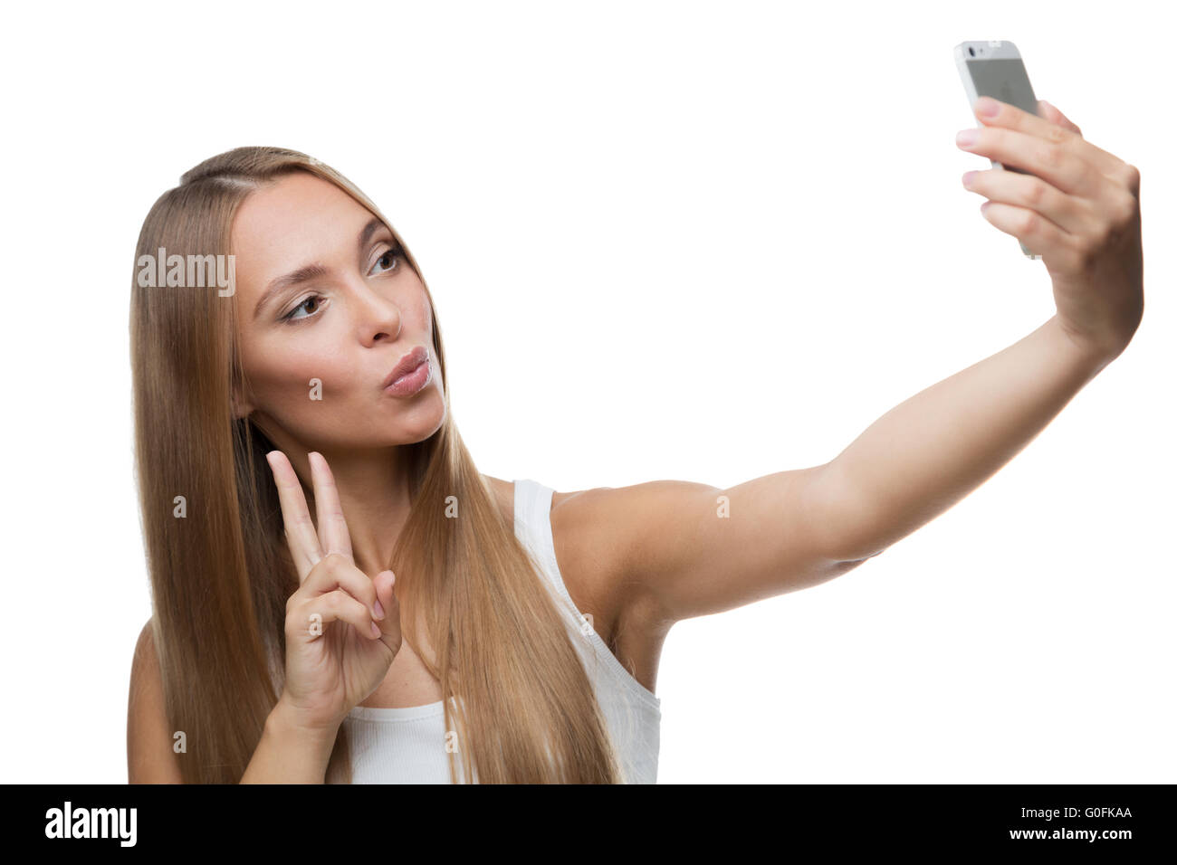 Bella donna fanno selfie su sfondo bianco Foto Stock