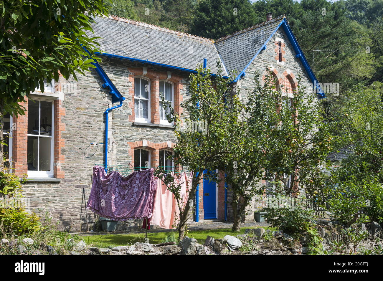 Cornish House con alberi da frutto e un servizio lavanderia spazio nel cortile anteriore. Foto Stock