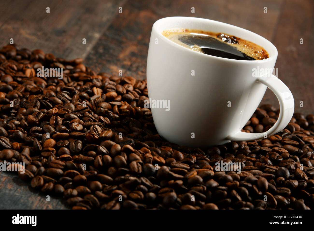 Composizione con tazza bianca e i chicchi di caffè. Foto Stock