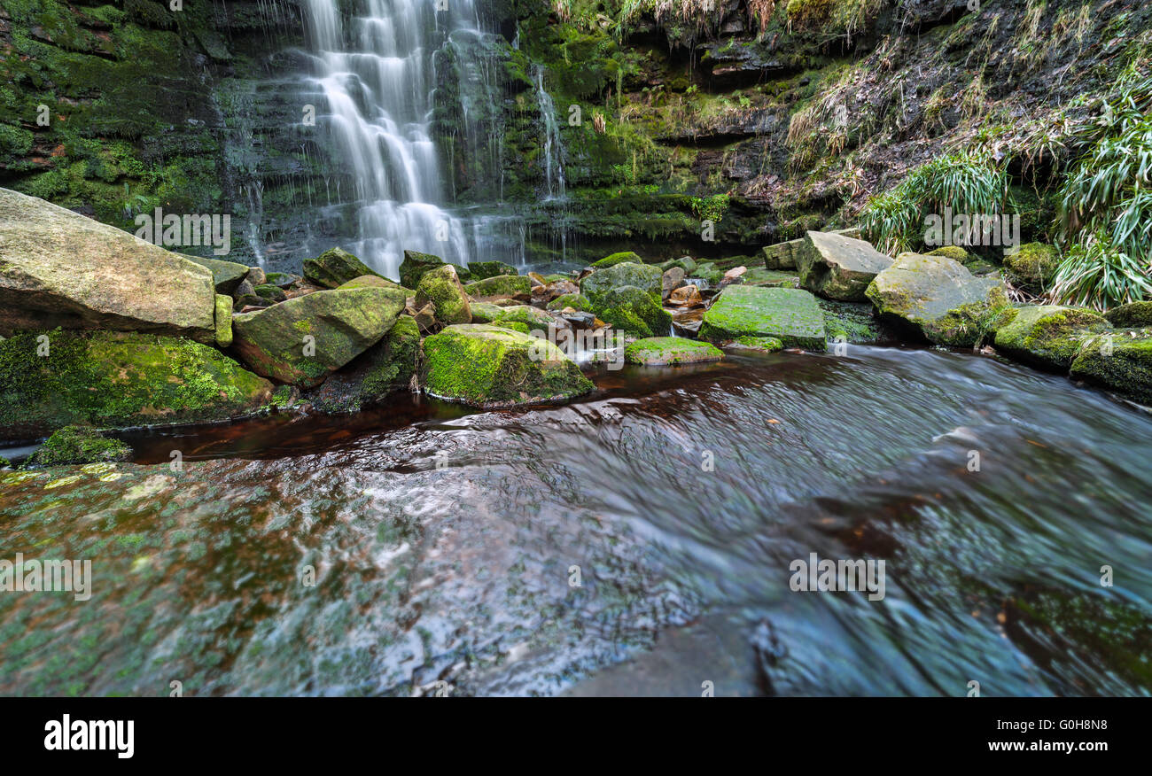 Cancellare una cascata cascata e pietre ricoperto in verde muschio Foto Stock