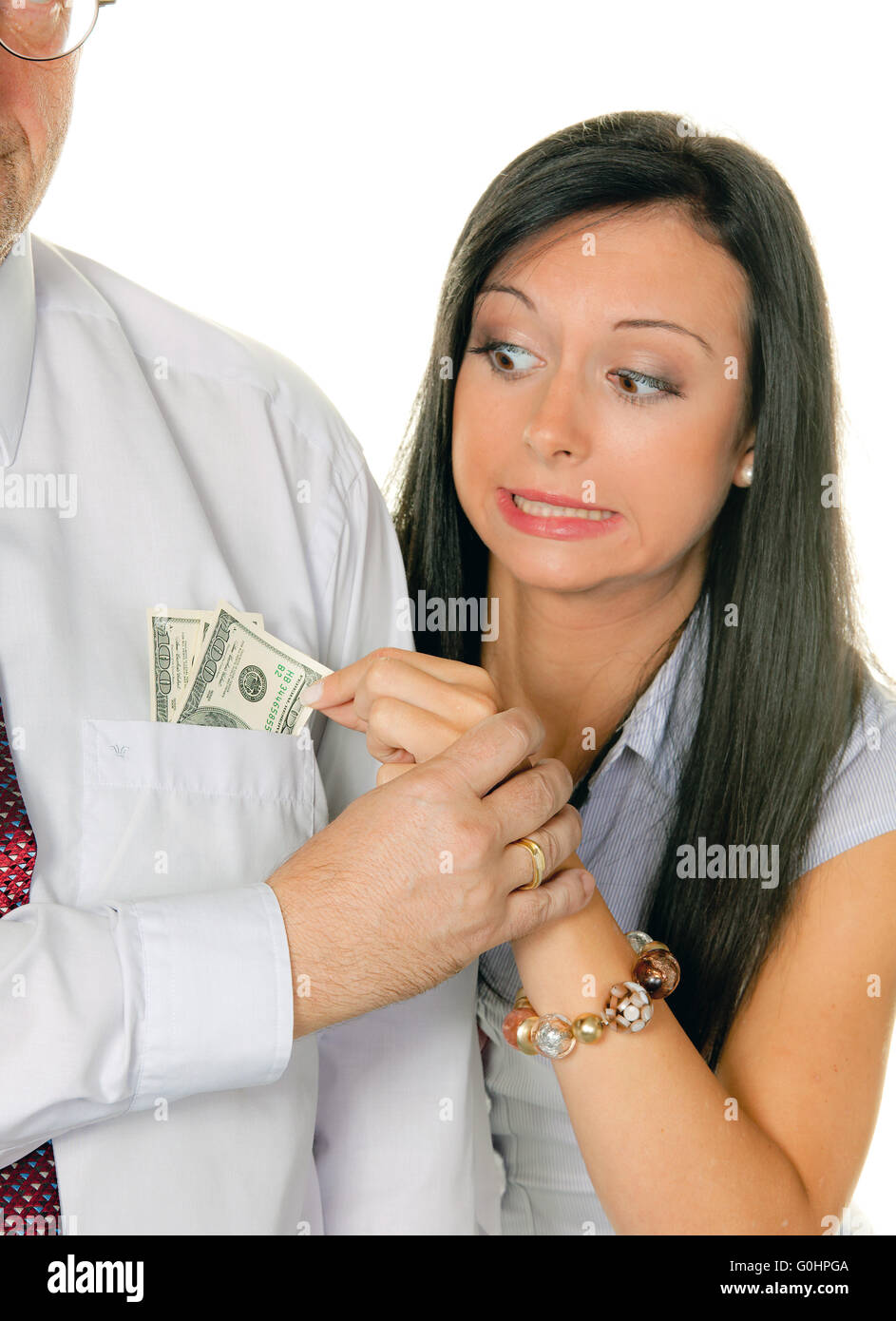 La donna tira un uomo fuori del denaro Tasche.Dollar Foto Stock