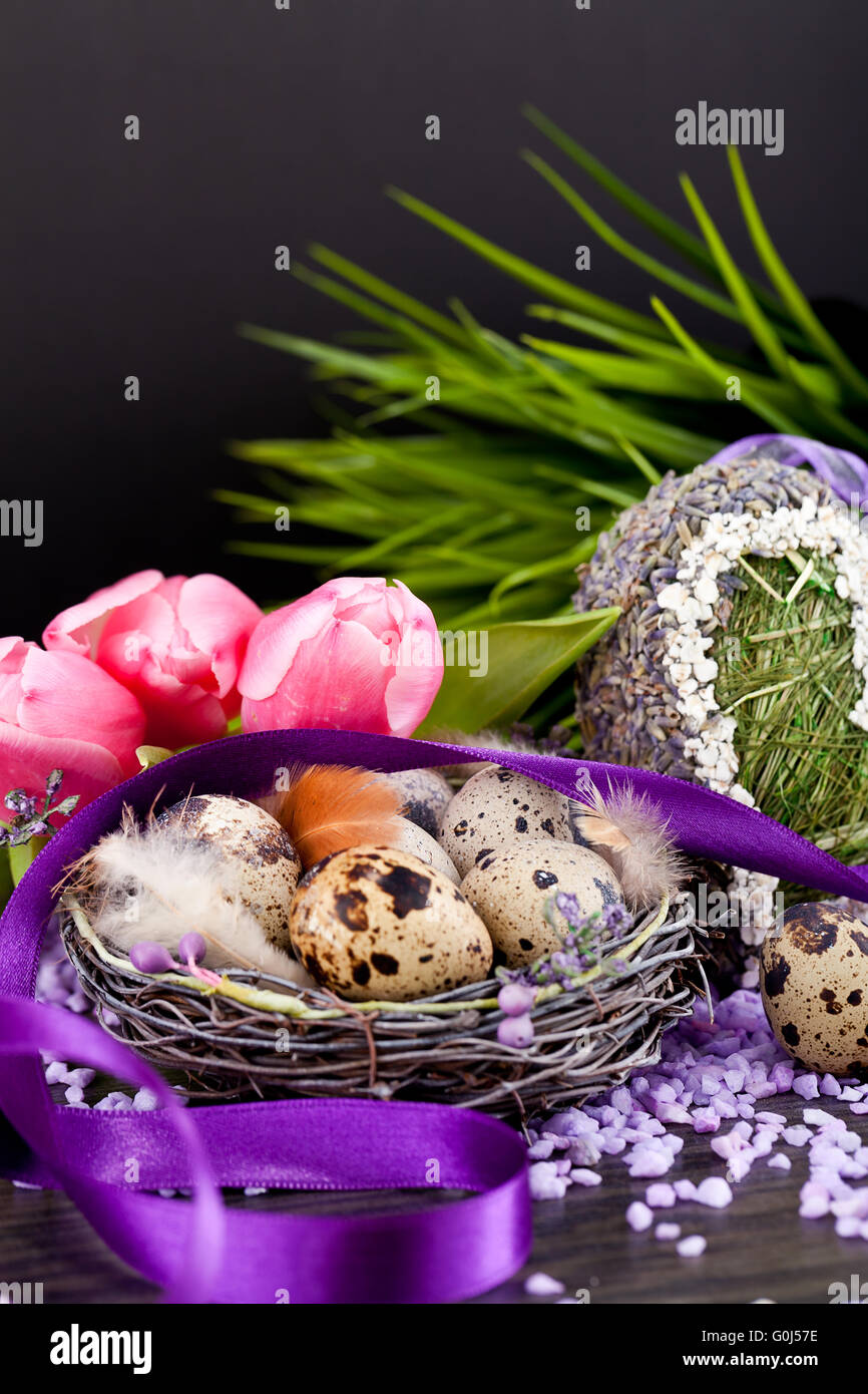 Tulipani rosa e uova di colore marrone con nastro viola decorazione di pasqua Foto Stock