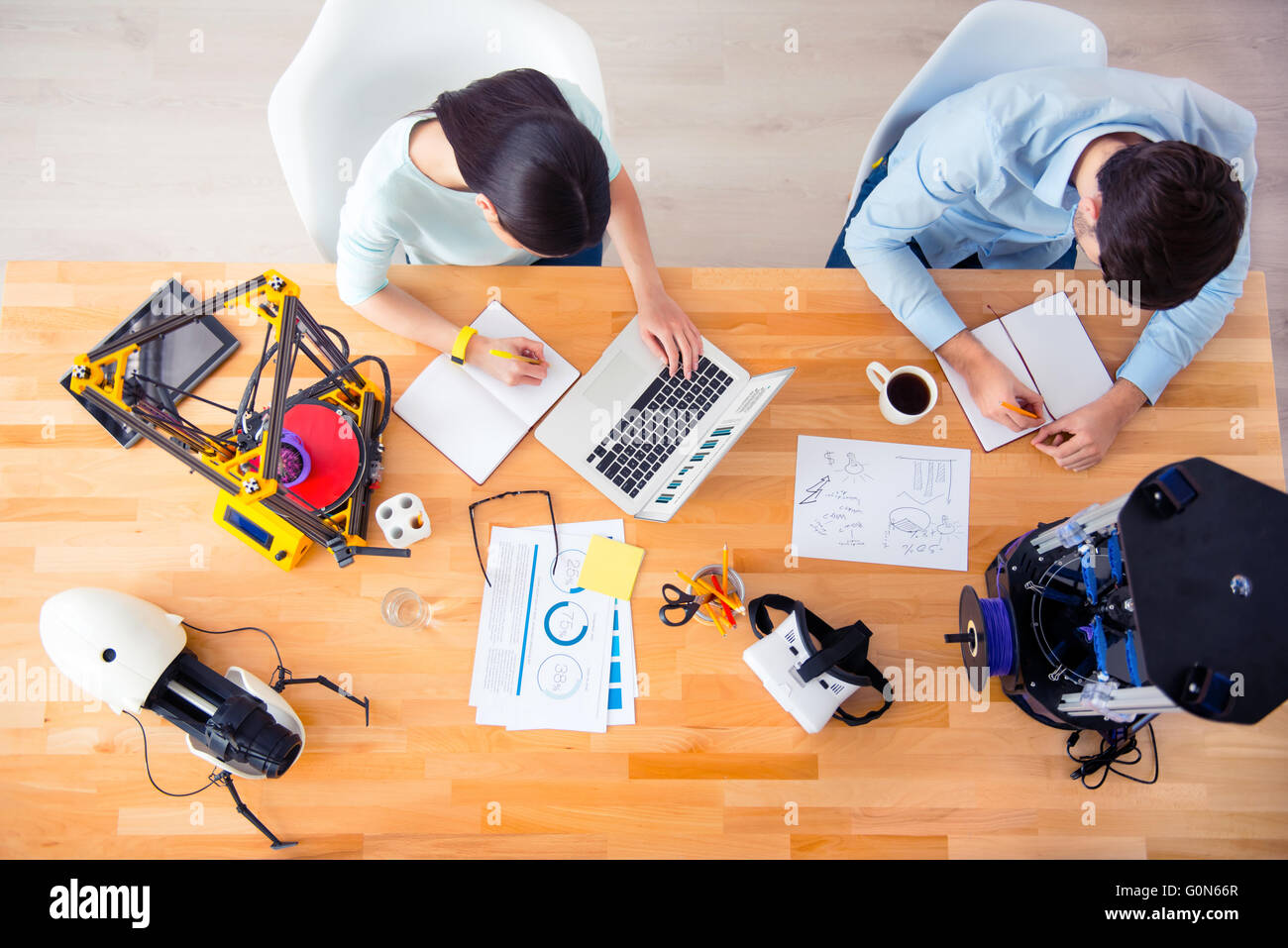 Piacevole gli studenti seduti a tavola Foto Stock