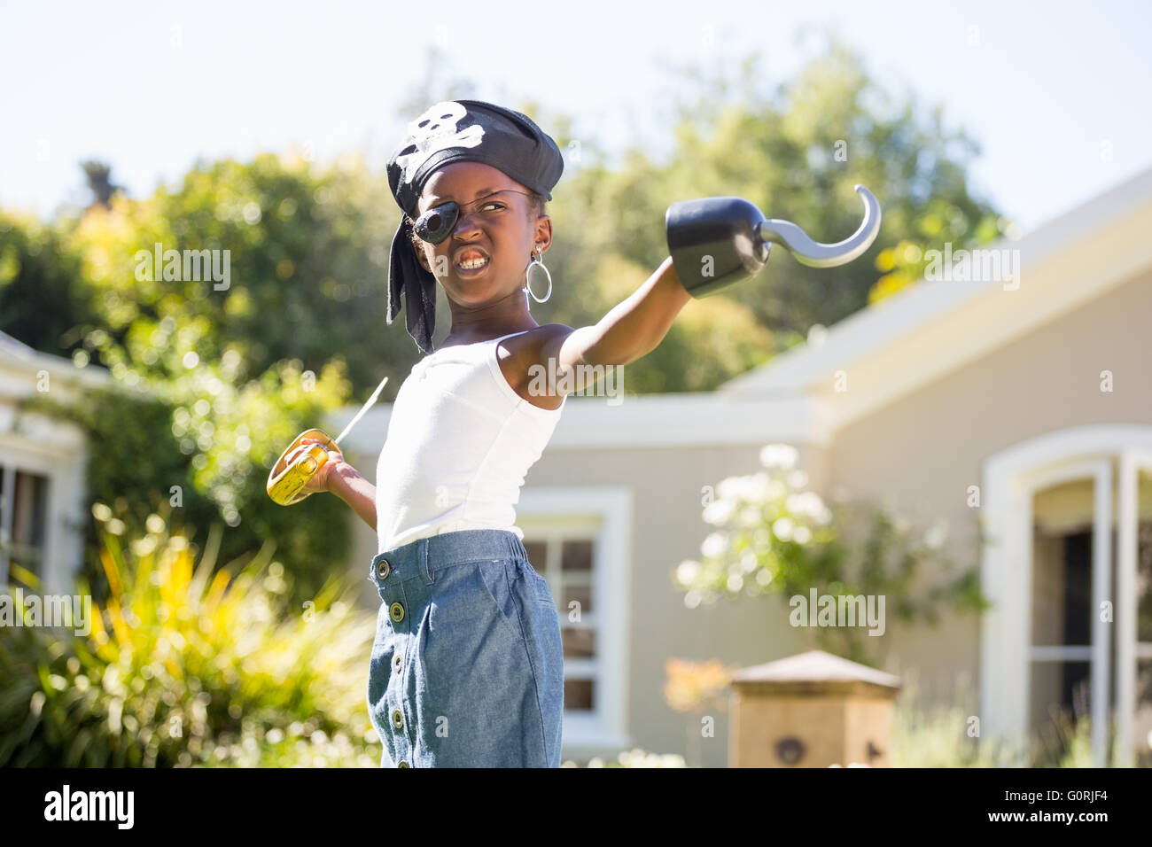 Carino mixed-gara ragazza smorfie e indossando i vestiti dei pirati Foto Stock