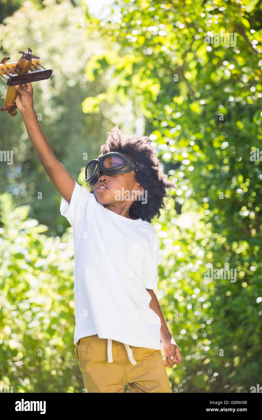 Ragazzo giocando con un giocattolo aereo a park Foto Stock