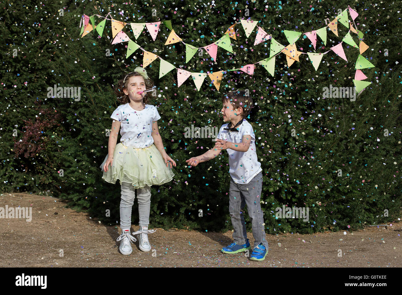Un ragazzo e una ragazza che celebra in un party in giardino Foto Stock