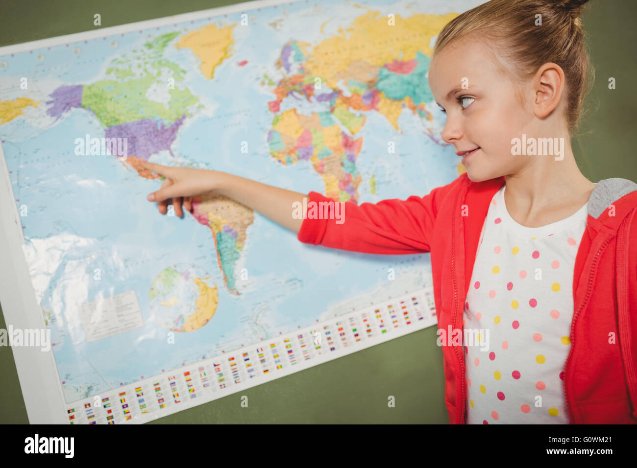 Ragazza puntando sulla mappa del mondo Foto Stock