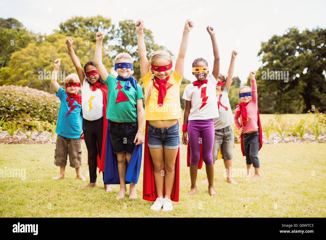 I bambini che indossano il costume del supereroe in piedi Foto Stock